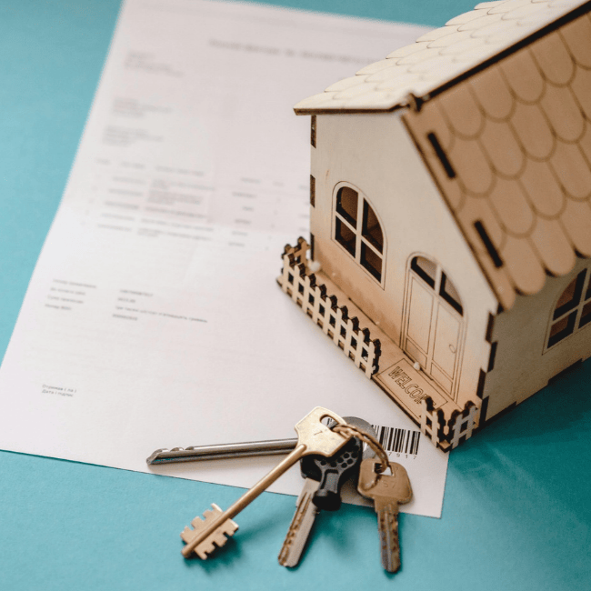 House keys handed over on top of a signed contract